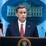 Чоловік у костюмі виступає за трибуною президента США на тлі емблеми Білого дому