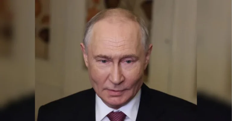 Володимир Путін у чорному костюмі та бордовій краватці дивиться вперед